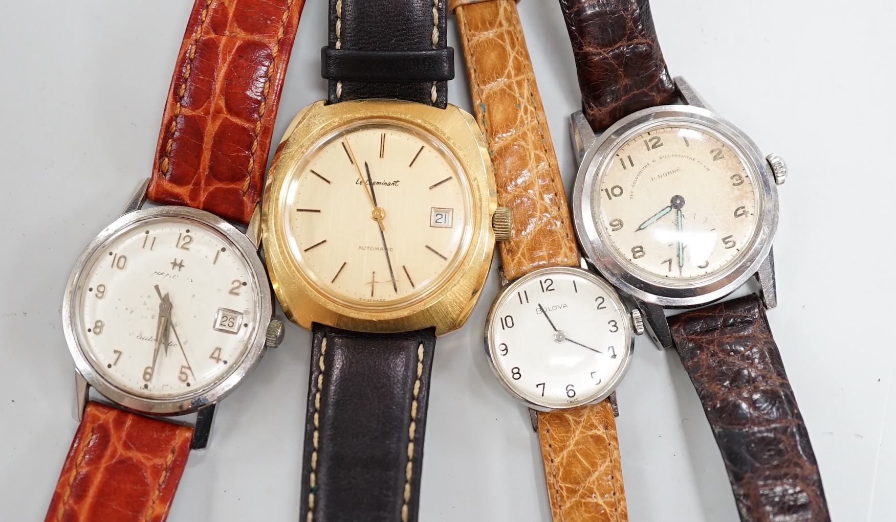 Three assorted gentleman's steel or gilt wrist watches, including retailed by Buhre and a lady's steel manual wind Bulova watch.